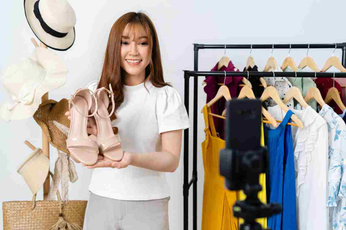 woman selling shoes and clothes online by smartphone live streaming, business